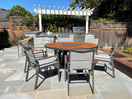 Switch 7 piece Dining set on patio in real natural sunlight Teak Taupe Aluminum Extruded powder coated Round dining table with stacking sling padded chairs-Bold with Summit 2 image