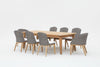 A 9-piece dining set with a rectangular teak table and six side chairs made of wicker