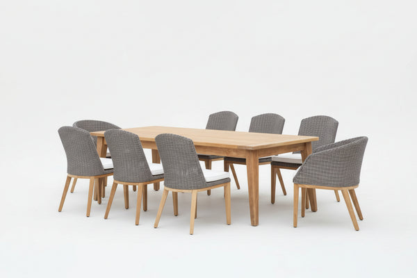 A 9-piece dining set with a rectangular teak table and six side chairs made of wicker