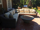 Switch Outdoor patio with wicker sectional sofa and fire pit table on a brick patio. 2 image