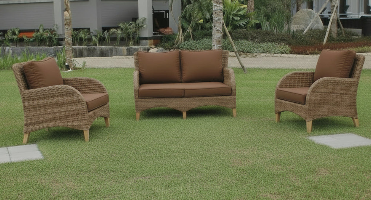Outdoor furniture set with wicker chairs and tables on a grassy area